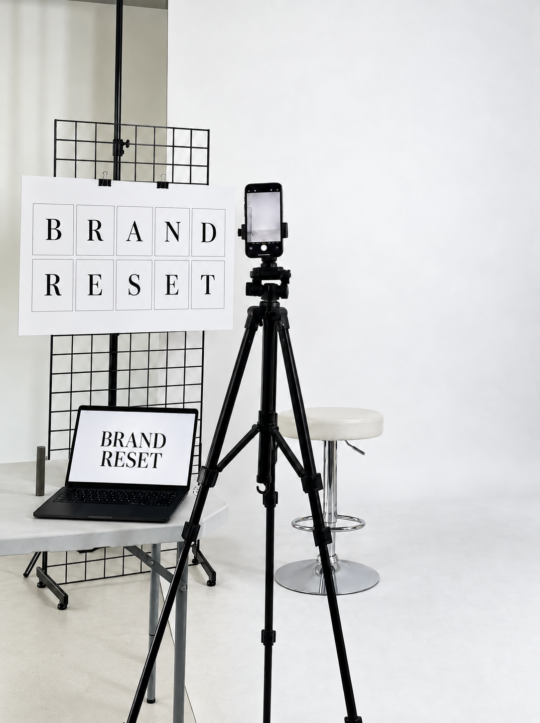 Vision to Brand Studio brand reset set with a camera, tripod, laptop, and white studio backdrop